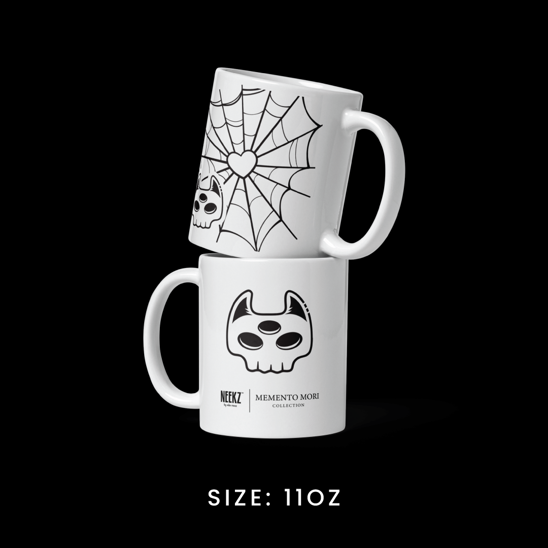 Stacked view of the 11oz mug from the Memento Mori collection, featuring Manxx the Magician graphics.